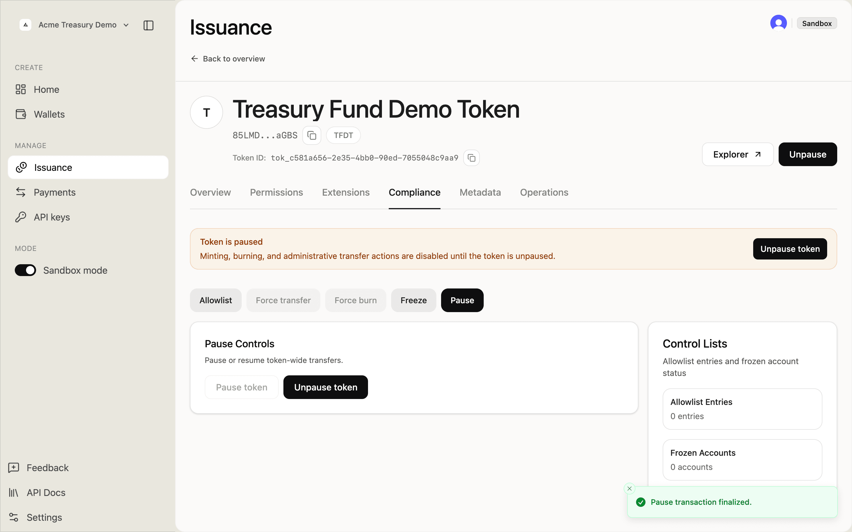 Compliance tab showing Token is paused banner and Pause transaction finalized toast